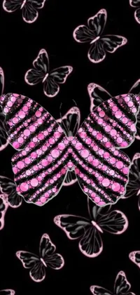 This phone live wallpaper showcases pink and black butterflies fluttering over a black background
