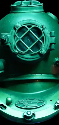 Looking for a serene live wallpaper for your phone? Check out this green diving helmet sitting on a table in a deep green underwater scene with bubbles rising around it