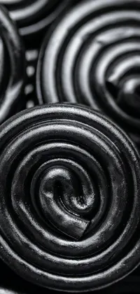 Satisfy your sweet cravings with this phone live wallpaper featuring a close up of chocolate candies captured in a charcoal drawing