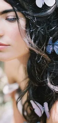 This beautiful live wallpaper features a stunning portrait of a woman with colorful butterflies perched in her hair