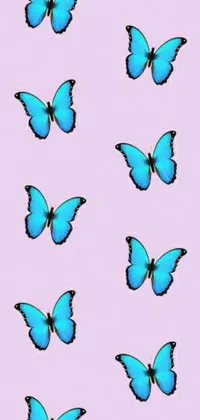 This phone live wallpaper showcases a playful and trendy digital art pattern of blue butterflies on a soft pink background