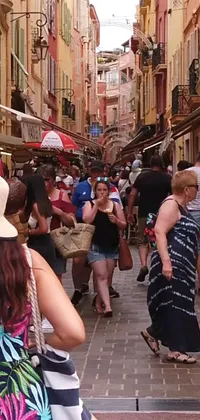 A dynamic phone live wallpaper featuring a bustling city street with a large crowd of people walking past towering buildings