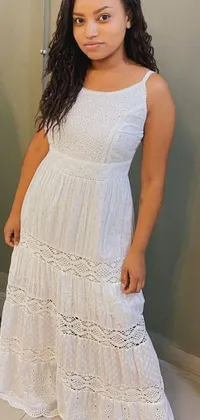 Enhance your phone display with this stunning live wallpaper! Featuring a beautifully detailed Mexican woman in a white maxi dress, standing in front of a mirror with a picture of herself on Instagram in the background