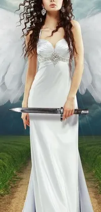 This phone live wallpaper features a graceful angel holding a sword and standing before a stunning sunset backdrop