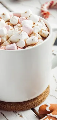 This phone live wallpaper features a delightful scene of a cup of hot chocolate, marshmallows and ginger cookies in warm tones of white and pink