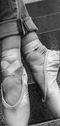 This stunning live phone wallpaper features a black and white photograph of ballet shoes