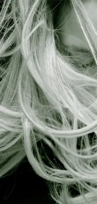 This live wallpaper for your phone features a captivating black and white image of a woman with long hair