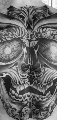 This phone live wallpaper features a stunningly detailed tattoo design inspired by shock art