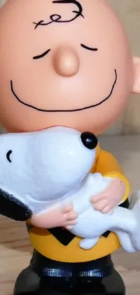 Get this charming phone live wallpaper featuring an adorable PVC figurine holding a little dog