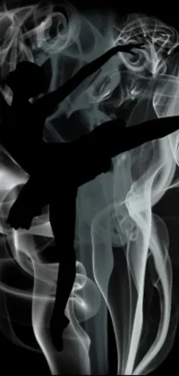 This live wallpaper depicts a stunning black and white photo of a dancer in an arabesque pose, set against a psychedelic smoke background