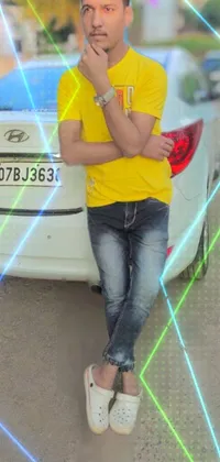 This phone live wallpaper features a modern image of a young man sitting on the back of a white car