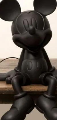 This charming phone live wallpaper depicts a black matte Mickey Mouse lamp sitting atop a wooden table