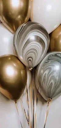 This live wallpaper features a collection of colorful balloons delicately floating above a baroque gold-patterned table