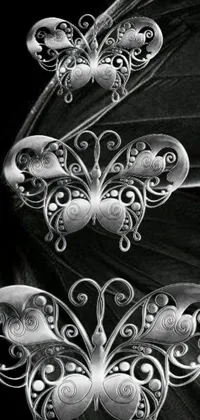 This stunning live wallpaper features a black and white photo of a butterfly adorned with silver ornaments