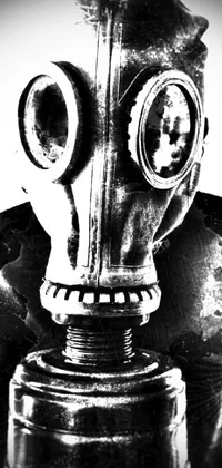 This stunning live wallpaper features a high contrast black and white photo of a gas mask, captured in a close-up portrait style
