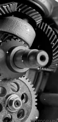This phone live wallpaper showcases a stunning black and white photograph of a gear wheel with precisionism and an Instagram filter