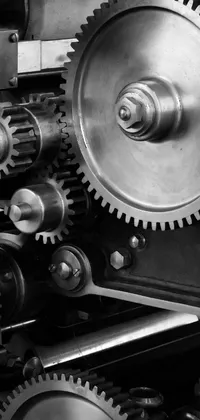 This live wallpaper features a mesmerizing black and white photograph of gears, vehicles, balances, and pulleys, giving off an industrial and modern vibe