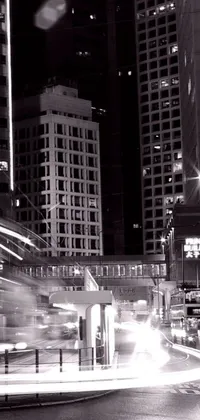 Experience the high-speed thrill of a bustling metropolis at night with this stunning black and white live wallpaper