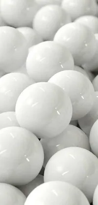 This phone wallpaper showcases a striking stack of white balls with a glossy finish