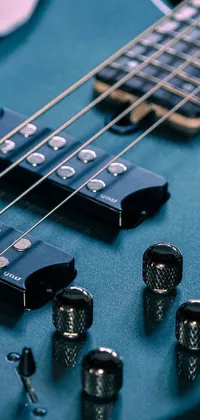 This captivating live wallpaper for your phone features a close-up shot of a guitar in its case, set against a background of cool blue tones, with mesmerizing sound waves on circuitry adding to the overall charm
