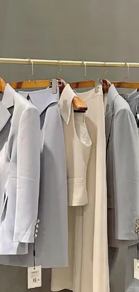 This live phone wallpaper features a row of clothes hanging on a clothes rack in a light blue suit style, with a muted color palette of mainly white, soft blues, and greys