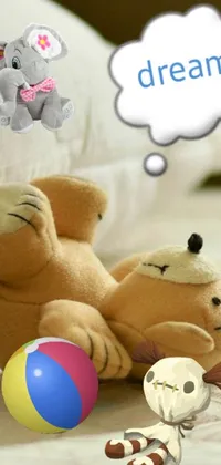 This lively mobile live wallpaper features a cuddly teddy bear resting atop a comfy bed, accompanied by a colorful beach ball and a cute cartoon character in deep thought