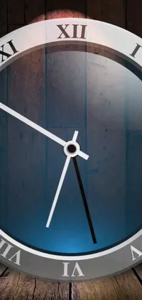 This live wallpaper features a modern clock design sitting on a wooden table
