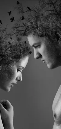 This stunning black and white live wallpaper features a romantic image of a man and woman standing in an enchanted forest
