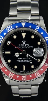 This phone live wallpaper features a Rolex watch with a stunning red and blue bezel, designed by Carlo Martini