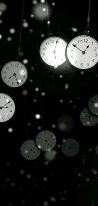 Are you looking for a stunning and unique live wallpaper for your phone? Look no further than this black-themed tumblr digital art design featuring a bunch of clocks hanging from a ceiling