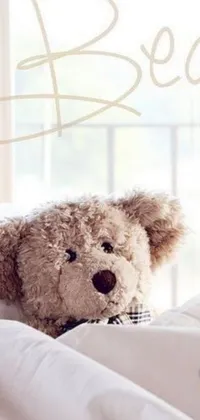This live wallpaper features an adorable brown teddy bear sitting on top of a cozy-looking bed