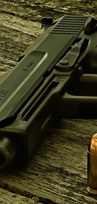 This live wallpaper showcases a captivating digital art depiction of a handgun on top of a wooden table next to a bullet