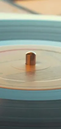 This live wallpaper features a close up of a vintage record with a stylized needle, spinning slowly on a table