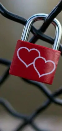 This live phone wallpaper features a vibrant red padlock adorned with two whimsical hearts