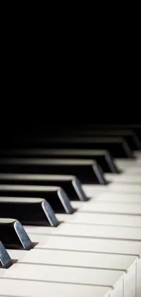 Enjoy a visually captivating live wallpaper on your phone with the keys of a grand piano in close-up view