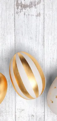 This stunning phone live wallpaper depicts a group of white and gold Easter eggs, adorned with intricate wood and gold details