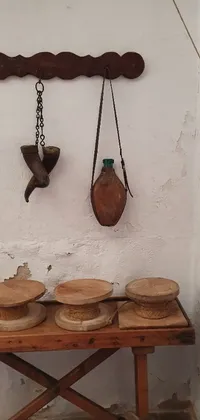 This live phone wallpaper displays a rustic table filled with antique pots and pans, surrounded by traditional cooking ingredients and utensils on a shelf behind it