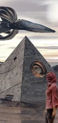 This live wallpaper showcases a futuristic man standing in front of an ancient pyramid bathed in an orange glow